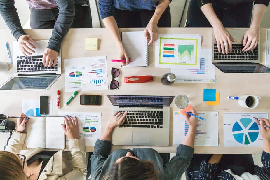 A team sitting at a table, working together. 