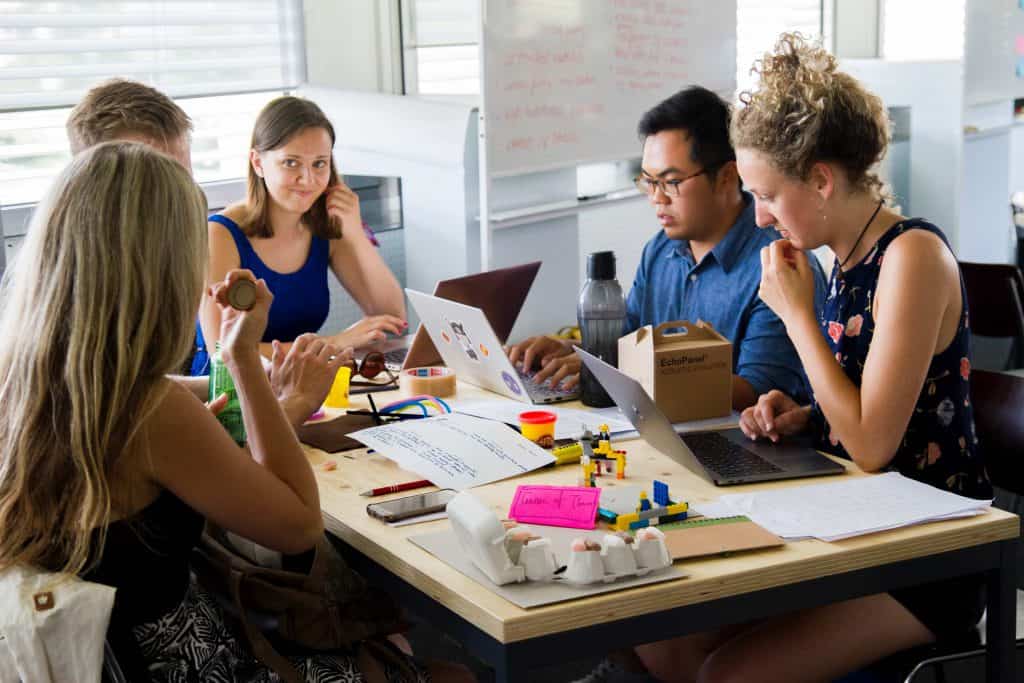 A team working together at a table on a project. 